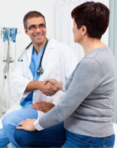 Team member shaking hands with a patient